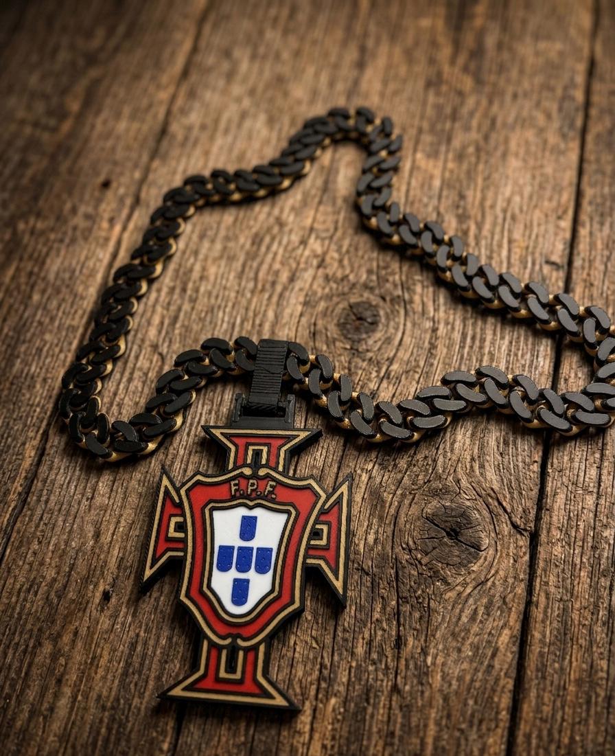 Portuguese fpf logo with black and god pendant on a wooden surface